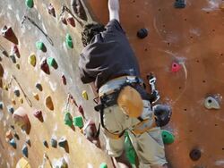 boy on an indoor climbing wall Stock Footage