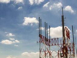 Communications tower time lapse clouds in pan shot Stock Footage