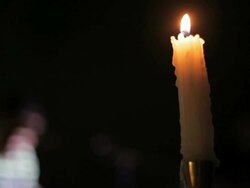 C/U candle (foreground), banjo player (background) Stock Footage