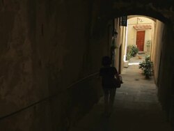WS Rear view of person walking down narrow alley / Tuscany, Italy Stock Footage