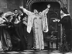 B/W 1900 Sarah Bernhardt as Queen Elizabeth acting melodramatic + fainting into throne / film Stock Footage