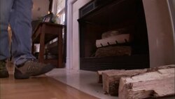 A man places firewood next to a fireplace. Stock Footage