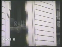 1935: COLD ROOM: * EXT VS Technician in aviation suit entering freeze room. MCU Door handle locking from inside. INT VS Technician checking engine of car frozen over w/ frost. MS Technician at control board behind glass flipping switch. Antifreeze Instructional Video