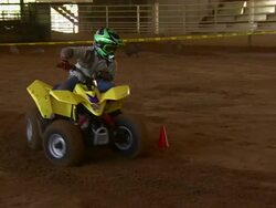 Child drives ATV through the obstacle course. Stock Footage