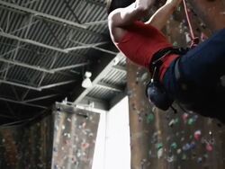 woman climbing on an indoor climbing wall Stock Footage