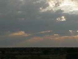 Timelapse suns rays through clouds as heavy clouds become lighter over desert, Kalahari, South Africa Stock Footage