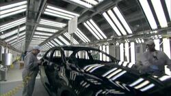 Factory workers inspect and polish a new automobile. Stock Footage