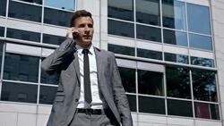 SLO MO Yuppie have a call while leaving the office Stock Footage