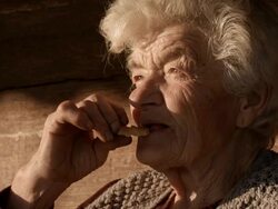Old Granny Eating Christmas Cookie Stock Footage