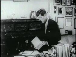 U. S. President, John F. Kennedy sits in his office with his book Profiles In Courage. News Clip