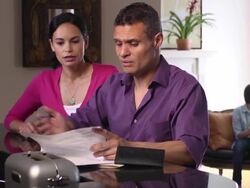 Latin Parents Discuss Home Finances with Kids in Background Stock Footage