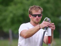 MS SLO MO Shot of Young farmer fixes irrigation sprinkler at organic farm / Chatham, Michigan, United States Stock Footage