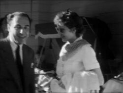 B/W 1937 Claudette Colbert talking with man at outdoor party at Pickfair / home movie Stock Footage