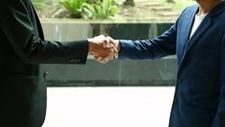Business shaking hands for accept agreement in Office interior Stock Footage