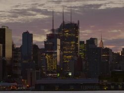 Shot of the Midtown Manhattan Skyline against a blue and purple sky in the late afternoon. The Chrysler Building, New York Times Building, and the H&M Building are clearly visible Stock Footage