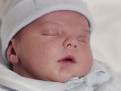 ECU Shot of Infant baby boy sleeps, wakes, yawns, wipes eyes / Beaverton, Oregon, United States  Stock Footage