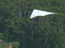 WS AERIAL ZI View of paragliding over town / Stanwell Park, Sydney New South Wales, Australia Stock Footage