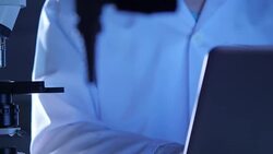 Scientist is using with microscope and laptop Stock Footage