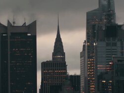 A gloomy city skyline.  The Chrysler building is featured.  Clouds race by behind Stock Footage