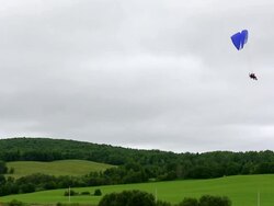 A paramotor flying in a cloudy sky Stock Footage