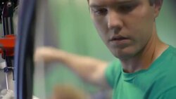 Bike mechanic inspects spinning wheel and squeezes brake lever on bicycle handlebar in repair shop Stock Footage