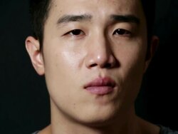 CU Shot of man showing Impassive expression and blinking eyes / Seoul, South Korea Stock Footage