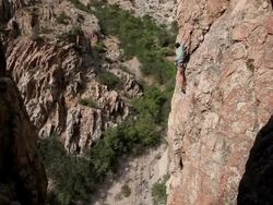 Handheld shot of a man on a cliff far from the ground. Stock Footage
