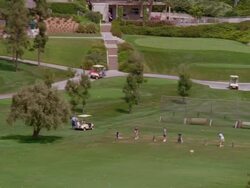 WS TD PAN View of golfers teeing off golf country club, clubhouse in bg/ Pasadena, California, USA Stock Footage