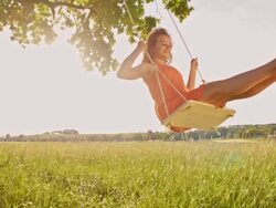 SLO MO Girl having fun swinging on tree swing Stock Footage