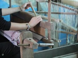 Woman working on weaving loom Stock Footage