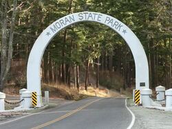MS Shot of cars going through entrance of Moran State Park in San Juan Islands / Orcas Island, Washington, United States Stock Footage