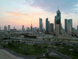 Arabian Peninsula, Kuwait, Kuwait City, elevated dusk view over the modern city centre architecture Stock Footage