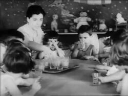 B/W 1934 children sitting at table drinking juice in nursery school / WPA project / newsreel Stock Footage