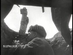 1943: RUSSIAN DEFENSE: WS Field w/ four Howitzer heavy guns, soldier behind firing artillery, black smoke ground explosion. Soldier in trench w/ sighting binoculars. Soldiers loading artillery, firing, explosion. MS Soldiers in trench w/ rifles, watch Instructional Video