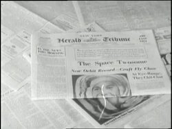 Newspaper headlines announce that two Soviet spacecrafts will circle the earth. News Clip