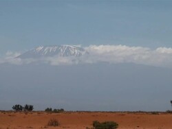 WS Kilimanjaro behind red soil savanna near amboseli national park AUDIO / Amboseli, Rift Valley, Kenya Stock Footage