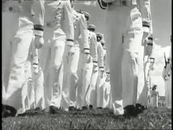 U.S. Air Force cadets in white uniforms march with rifles in formation. News Clip