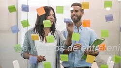 Business people looking at adhesive notes in conference room Stock Footage