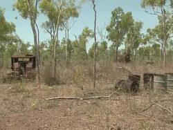 Old drums and vehicles rust in outback, Australia Stock Footage