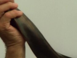 Close up pan of a Jewish man blowing on a shofar Stock Footage