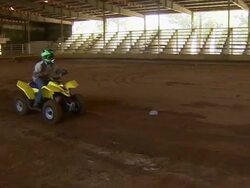 Long shot of child driving ATV through the obstacle course. Stock Footage