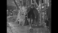 Currency reform instituted by Marshall Plan; Munich street scenes of people anxious for information News Clip