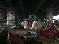 WS View of people living and working under road bridges / Lagos, Nigeria Stock Footage