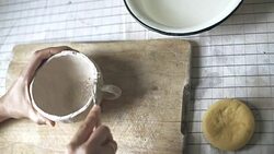 Hands working on ceramic cup Stock Footage