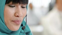 TU Female Muslim call center operator taking a call Stock Footage