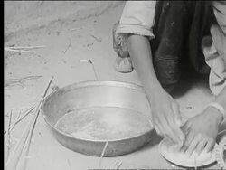 Women making food over a fire Stock Footage