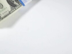 CU SLO MO Shot of Wads of 1 US Dollar Banknotes falling against White Background / Calvados, Normandy, France Stock Footage