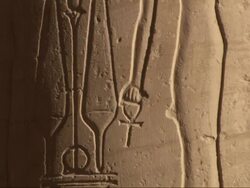 Medium Close Up, tilt-up - A wall contains ancient Egyptian drawings and hieroglyphics Stock Footage