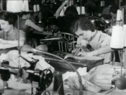 B/W 1934 woman using sewing machine in WPA garment factory / documentary Stock Footage