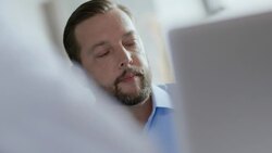 Restaurant owner consults computer and instructs staff in team meeting Stock Footage